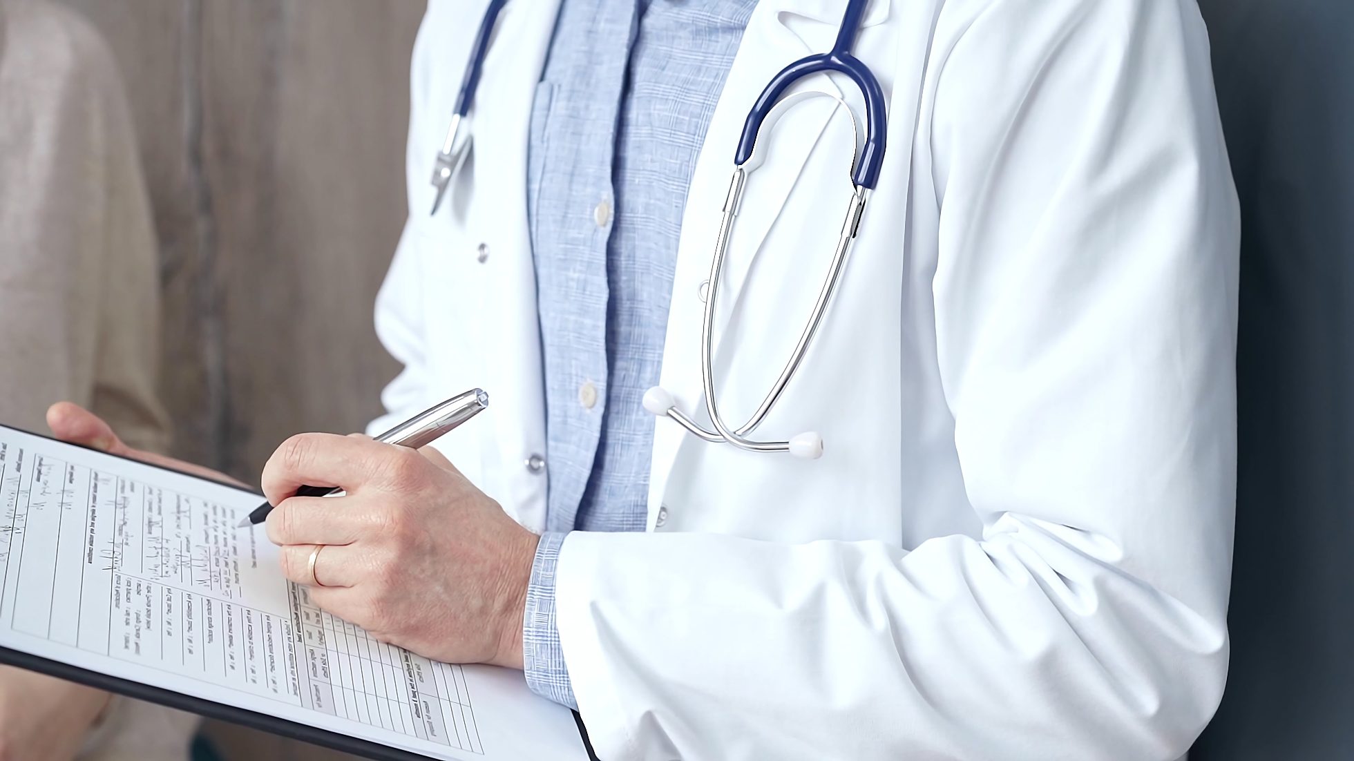 A doctor completing a medical history form.